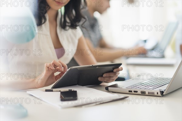 Close up of young woman and man working in office.