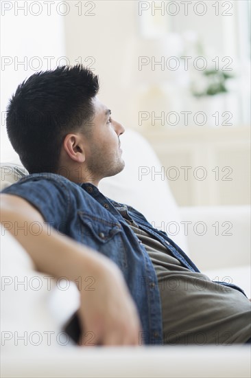 Young man relaxing on sofa.