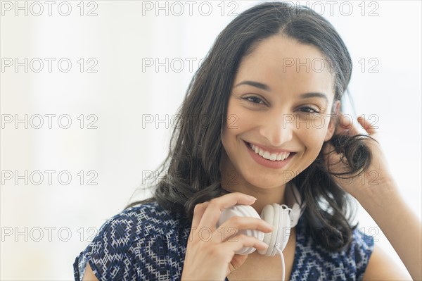 Portrait of smiling young woman with headphones.