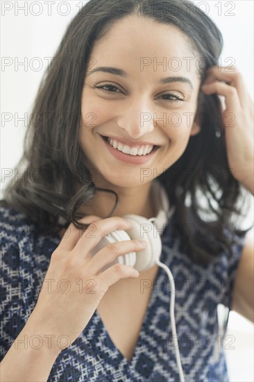 Portrait of smiling young woman with headphones.