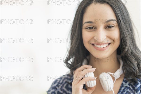 Portrait of smiling young woman with headphones.