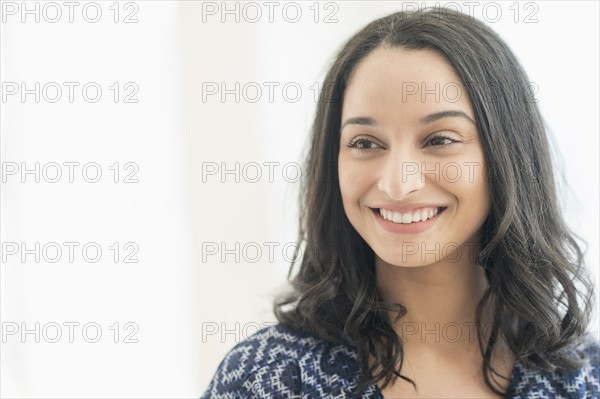 Portrait of smiling young woman .