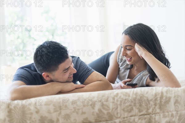 Young couple relaxing on bed.