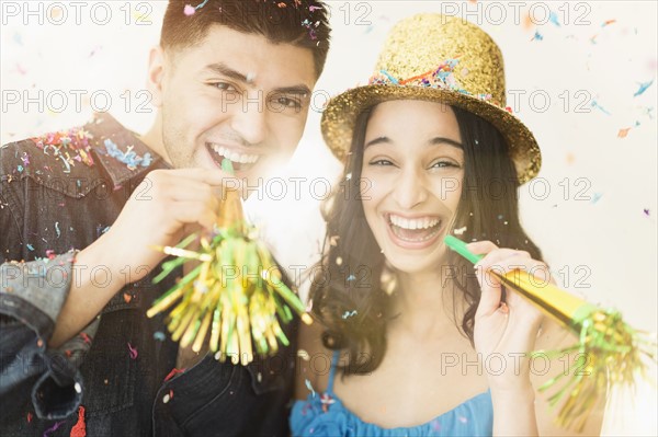 Young couple celebrating New Year's Eve.