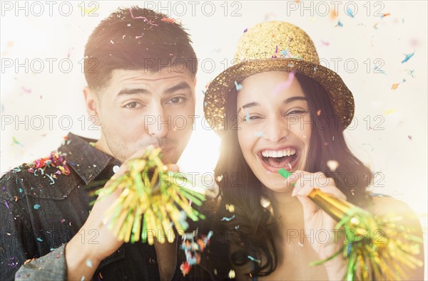 Young couple celebrating New Year's Eve.