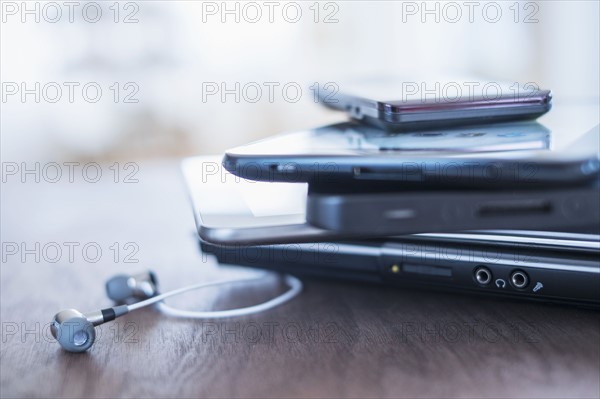 Close up of stack of devices on desk.