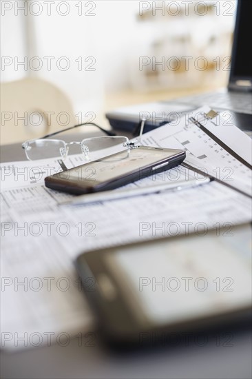 Close up of glasses on paperwork.