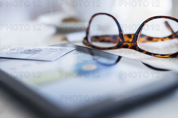 Close up of glasses and smartphone on table.