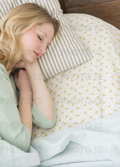 Young woman sleeping in bed.
Photo : Jamie Grill