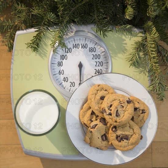 Studio Shot of cookies and milk on bathroom scale.
Photo : Jamie Grill