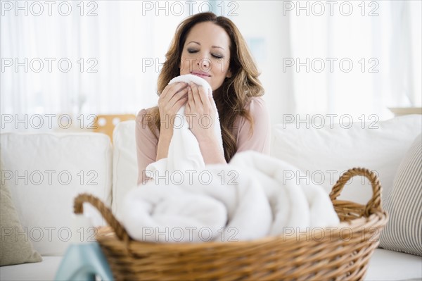 Woman smelling washed laundry.
Photo : Jamie Grill