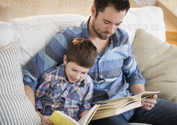 Father reading books with his son (8-9).
Photo : Jamie Grill