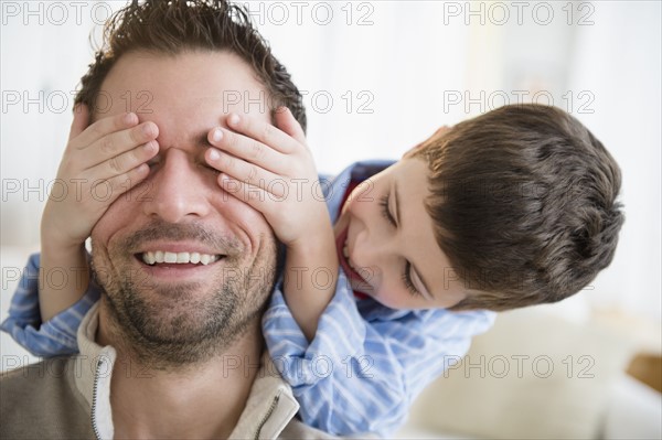 Son (8-9) covering father's eyes.
Photo : Jamie Grill