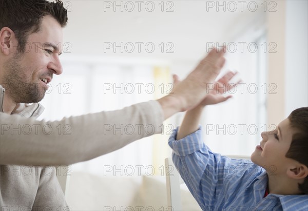 Father and son (8-9) high fiving .
Photo : Jamie Grill