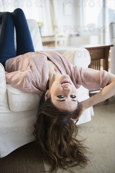 Young woman relaxing on sofa .
Photo : Jamie Grill