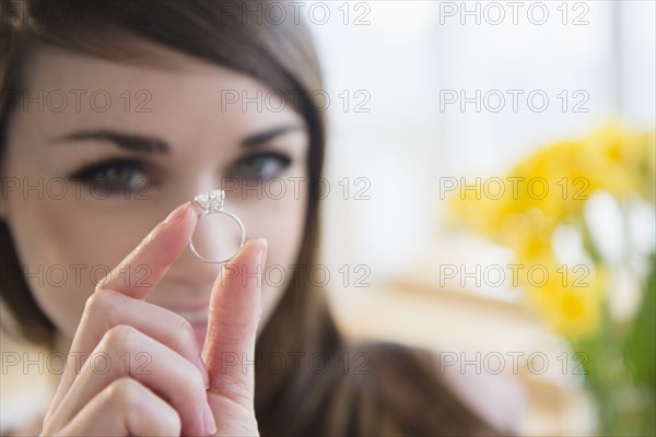 Young woman showing engagement ring .
Photo : Jamie Grill