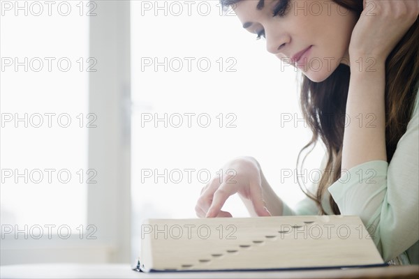 Young woman reading dictionary.
Photo : Jamie Grill