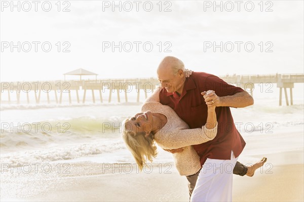 Senior couple dancing on beach.
Photo : Daniel Grill