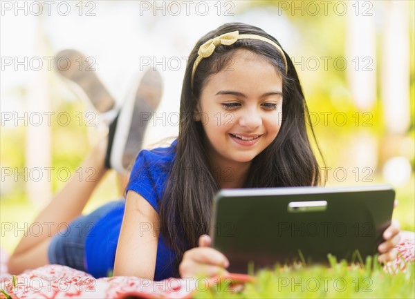 girl ( 8-9) using digital tablet .
Photo : Daniel Grill