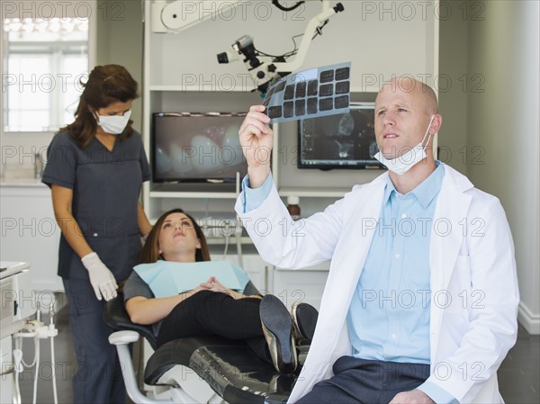 Dentist looking at x-ray.