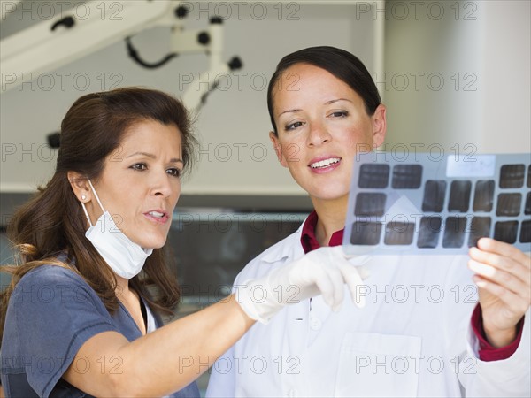 Dentist and assistant looking at x-ray.