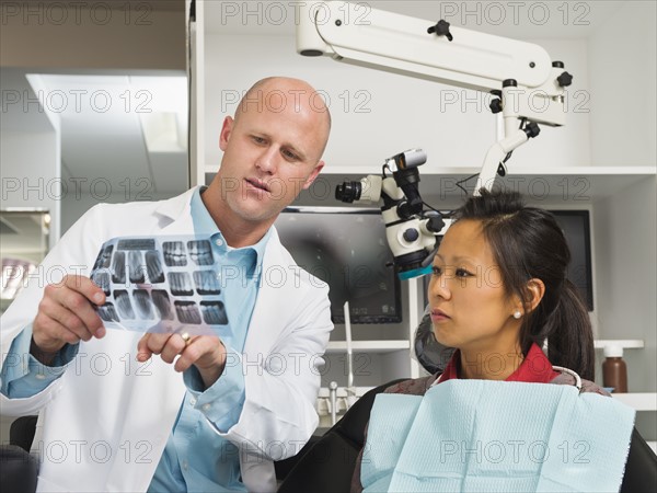 Dentist holding patient's x-ray.
