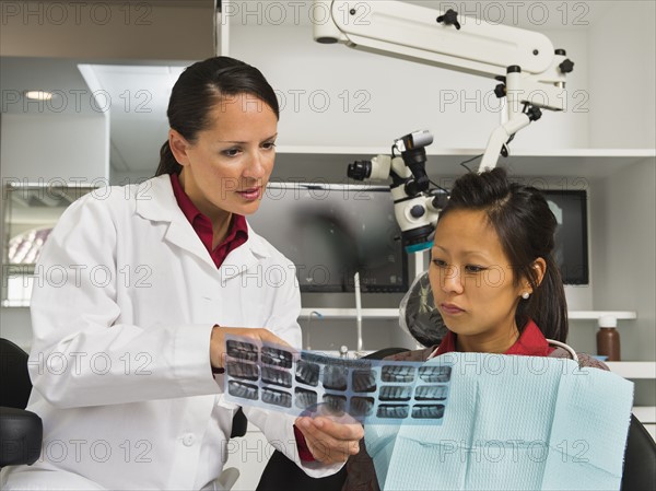 Dentist holding patient's x-ray.