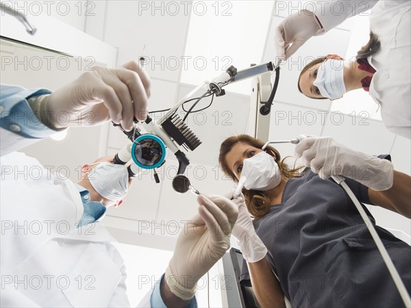 Lowe angle view of dentists and assistant.