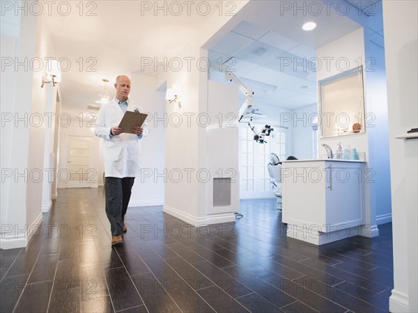 Doctor walking through corridor of clinic.