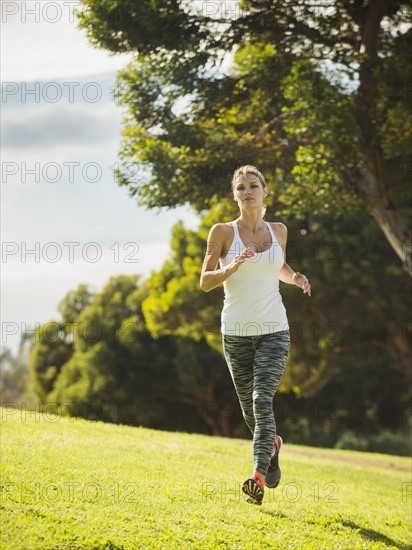 Woman running through lawn.