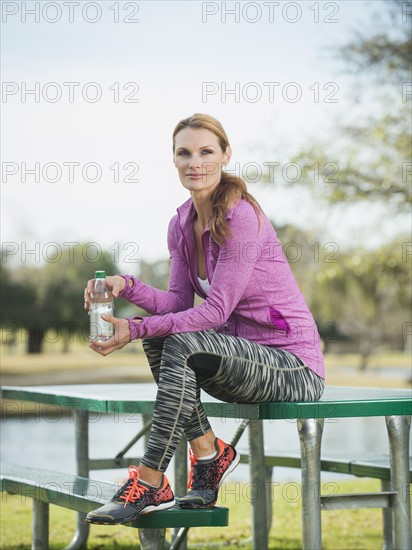 Portrait of woman is sports clothing in park.