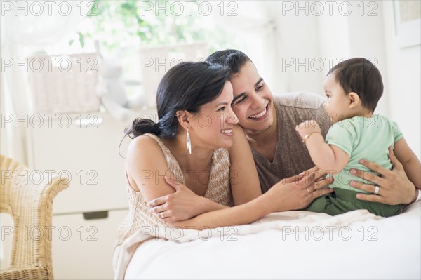 Family with baby son (6-11 months) in bedroom.