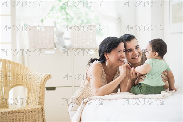 Family with baby son (6-11 months) in bedroom.