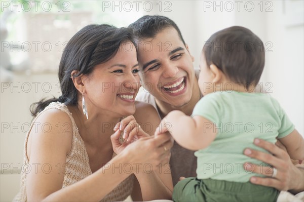 Family with baby son (6-11 months) in bedroom.