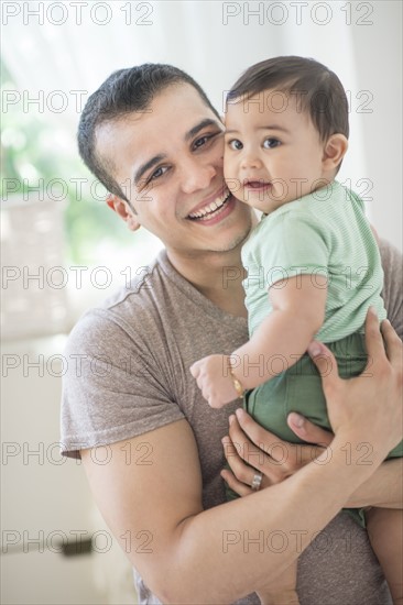 Father holding his son (6-11 months).