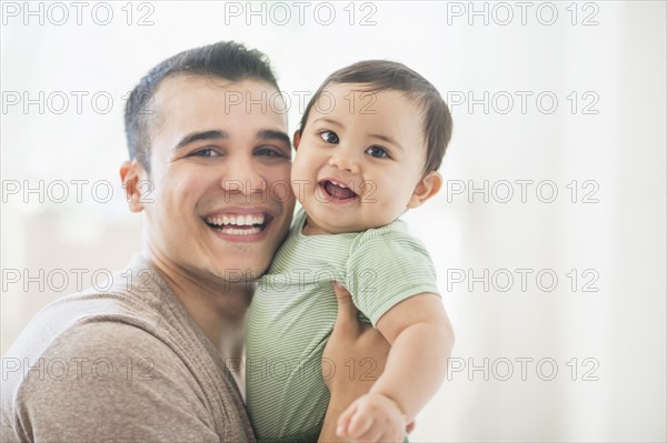 Father holding his son (6-11 months).