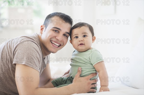 Father holding his son (6-11 months).