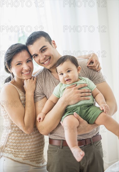 Family with baby son (6-11 months) in bedroom.