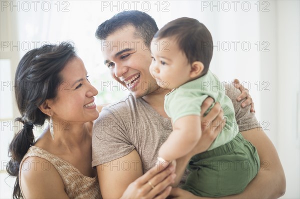 Family with baby son (6-11 months) in bedroom.