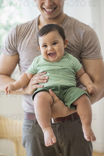 Father holding his son (6-11 months).