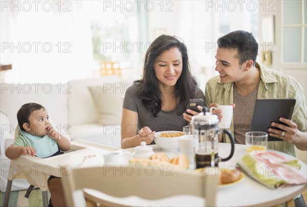 Family with baby son (6-11 months) in dining room.