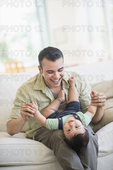 Father holding his son (6-11 months).