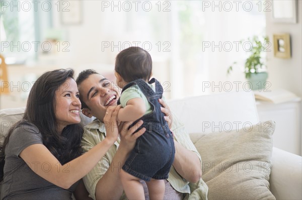 Family with baby son (6-11 months) in living room.