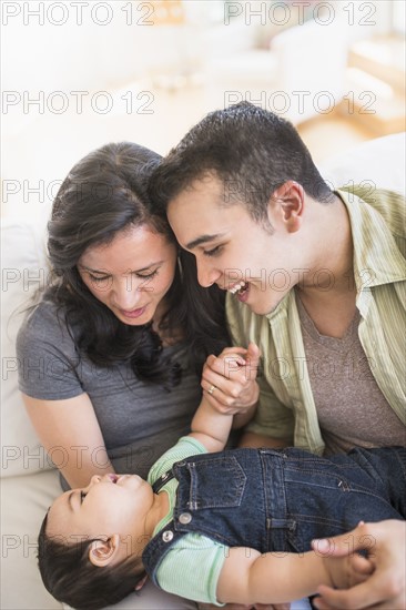 Family with baby son (6-11 months) in living room.