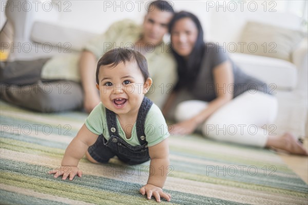 Family with baby son (6-11 months) in living room.