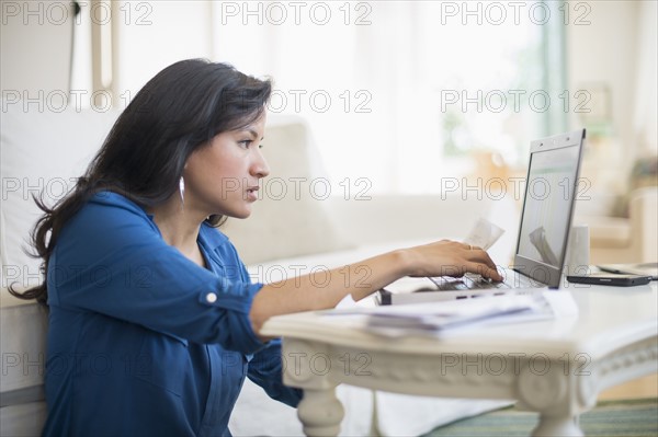 Woman working in living room.