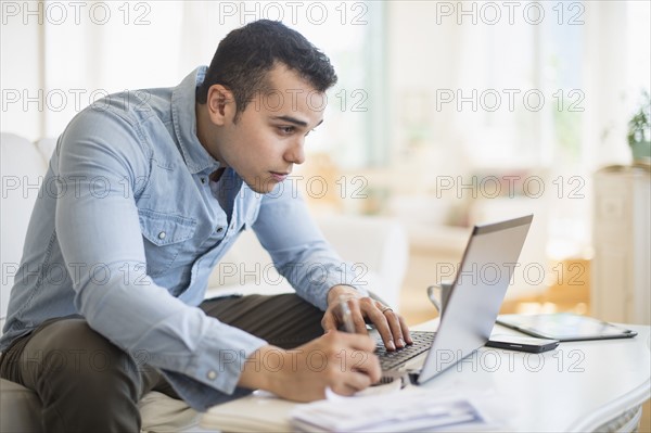 Man working in living room.