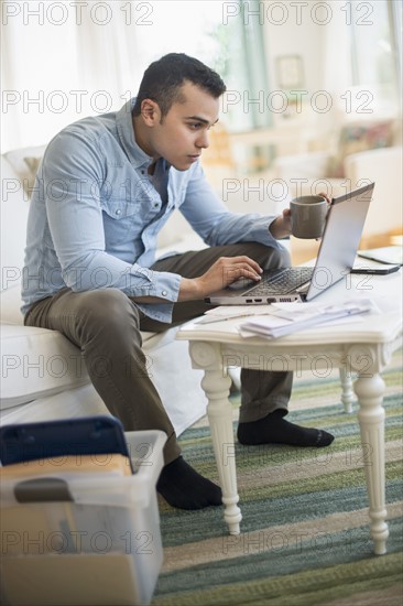 Man working in living room.