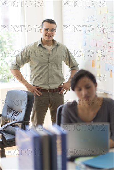 Two people working in office.