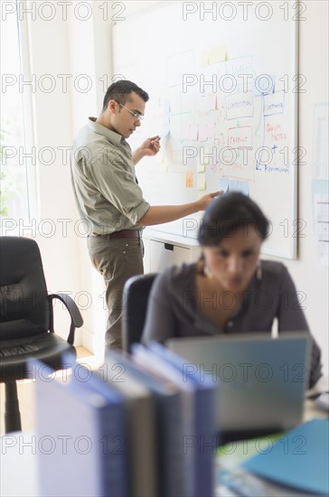 Two people working in office.